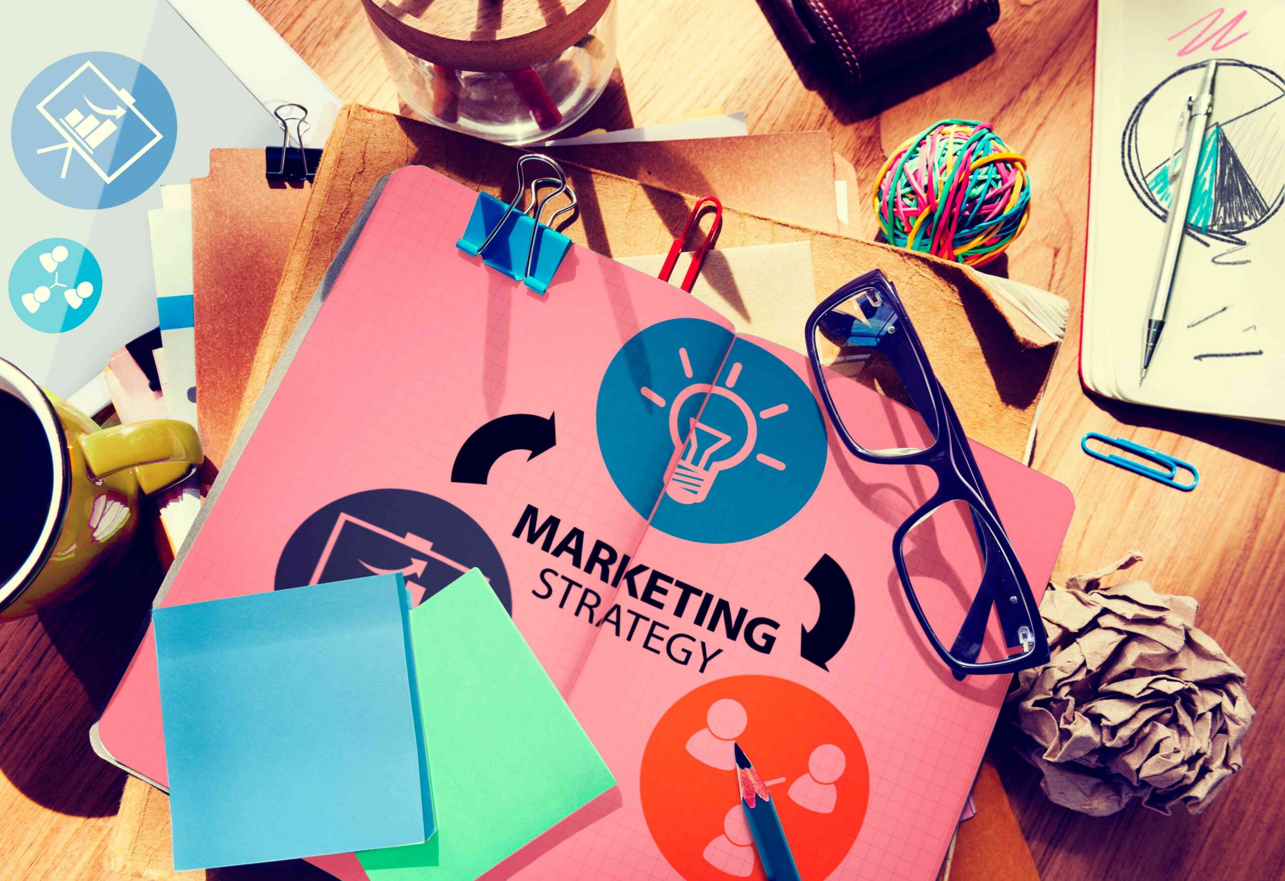 Colorful marketing strategy plan on a desk with sticky notes, glasses, and coffee cup, illustrating brand growth concepts for CAGnite.